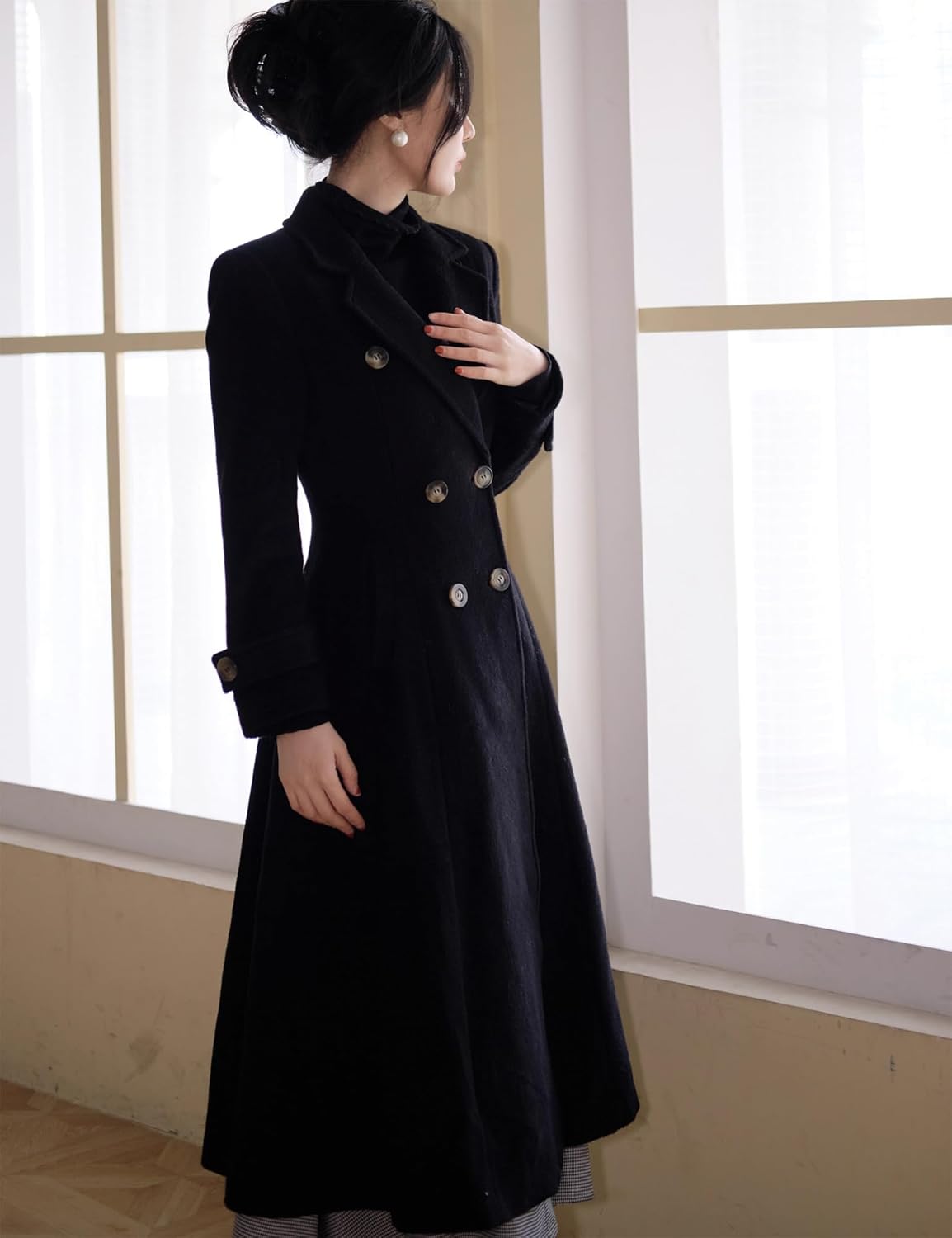 A women’s long wool-blend winter coat with a double-breasted front, notch lapel collar, and side pockets, designed to keep you warm and stylish through fall and winter. It has a knee-length silhouette that works for casual and dressier outfits alike.
